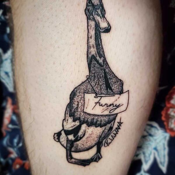 atticus tattoo, black and white tattoo of a duck with a sign that says "funny"