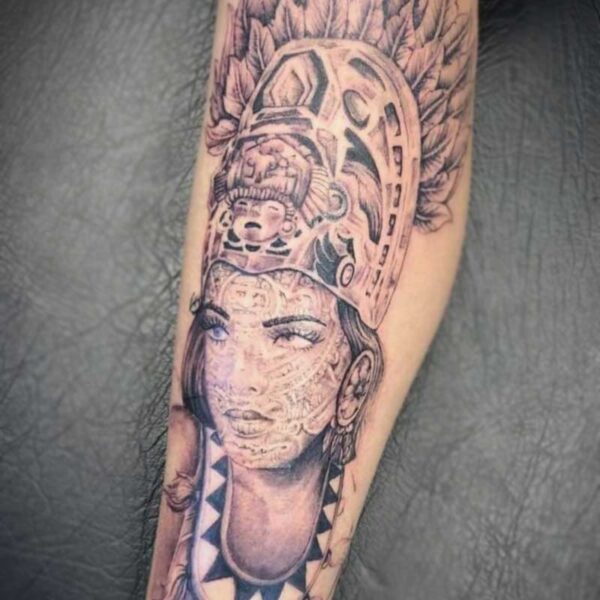 atticus tattoo, black and grey realism tattoo of a South American Indigenous woman with traditional face-paint and headgear