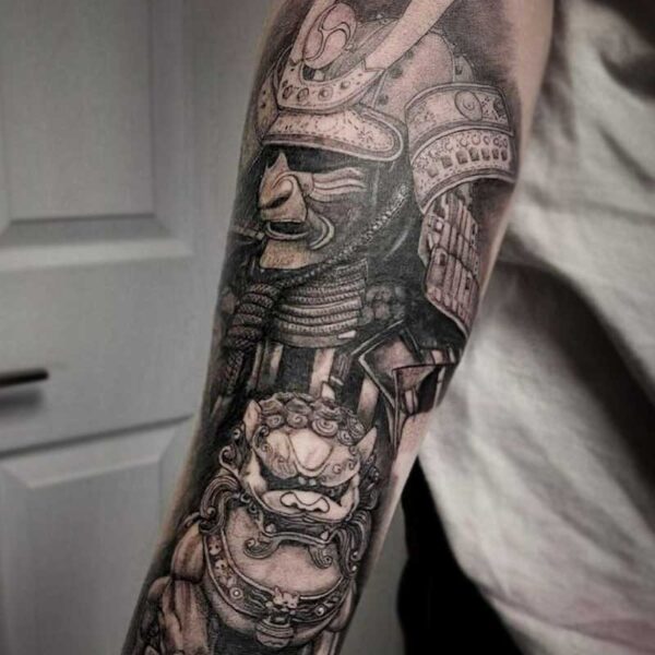 atticus tattoo, black and grey realism tattoo of a samurai with a lion statue