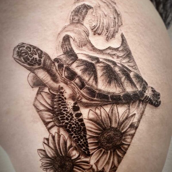 atticus tattoo, black and grey realism tattoo of a sea turtle, waves and sunflowers, all framed in a diamond shape
