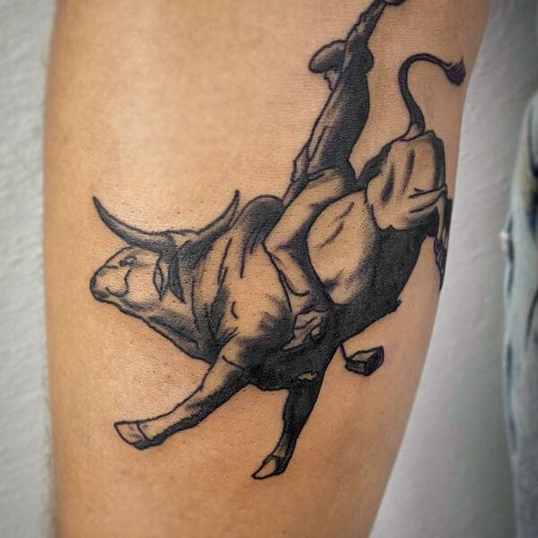 atticus tattoo, black and grey tattoo of a bull rider on a bucking bull