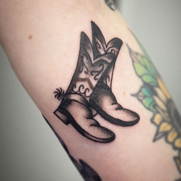 atticus tattoo, black and grey traditional tattoo of cowboy boots