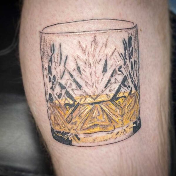 atticus tattoo, tattoo of a whiskey glass that is half full