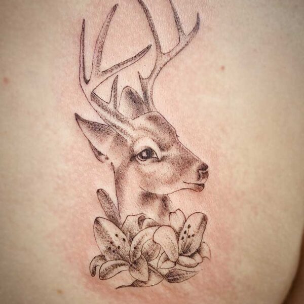 atticus tattoo, black and grey tattoo of a deer with lilies