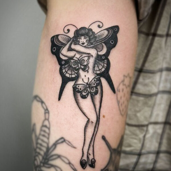 atticus tattoo, black and grey traditional tattoo of a woman with butterfly wings