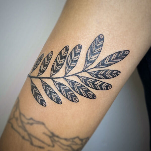 atticus tattoo, black and grey tattoo of leaves with a chevron pattern