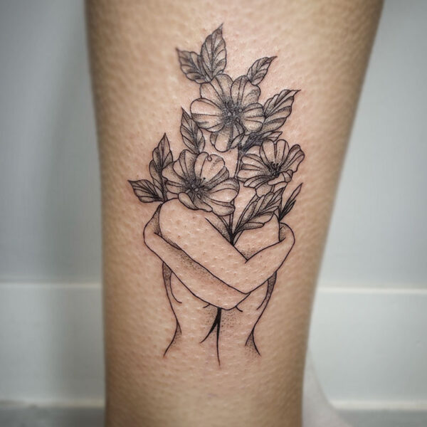 atticus tattoo, fine line tattoo of a woman hugging a bouquet of flowers