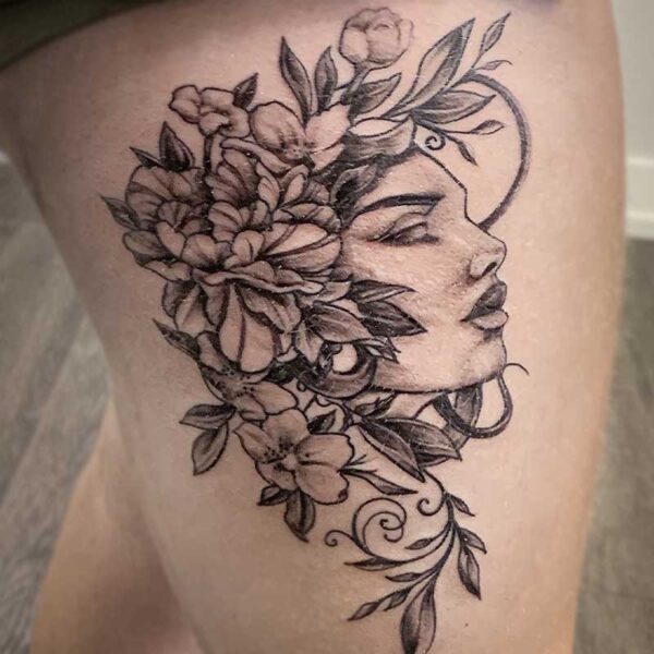 atticus tattoo, black and grey tattoo of a woman with flowers for her hair