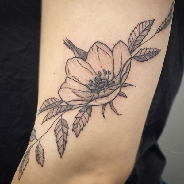 atticus tattoo, black and grey tattoo of a flower and leaves