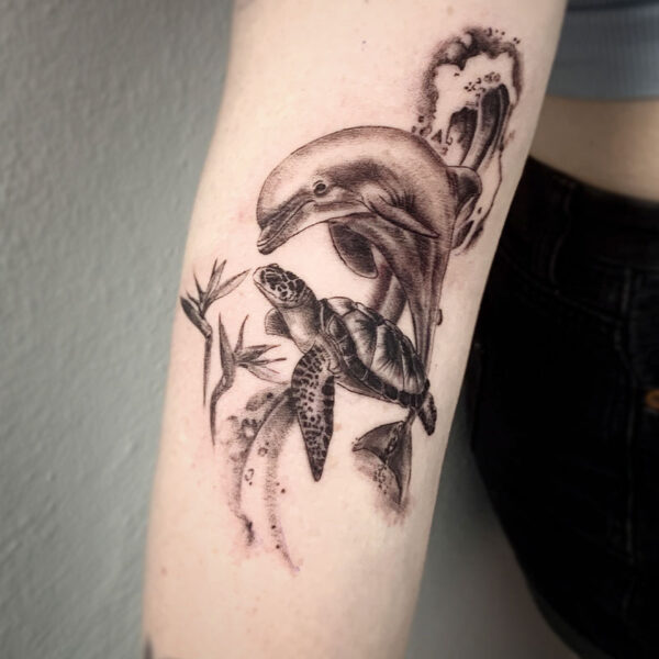 atticus tattoo, black and grey, realism tattoo of a dolphin and sea turtle