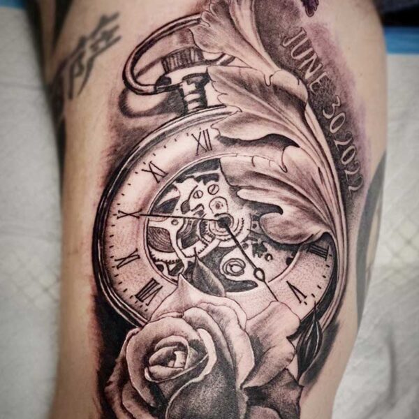 atticus tattoo, black and grey tattoo of a stop watch with a rose and decorative leaf