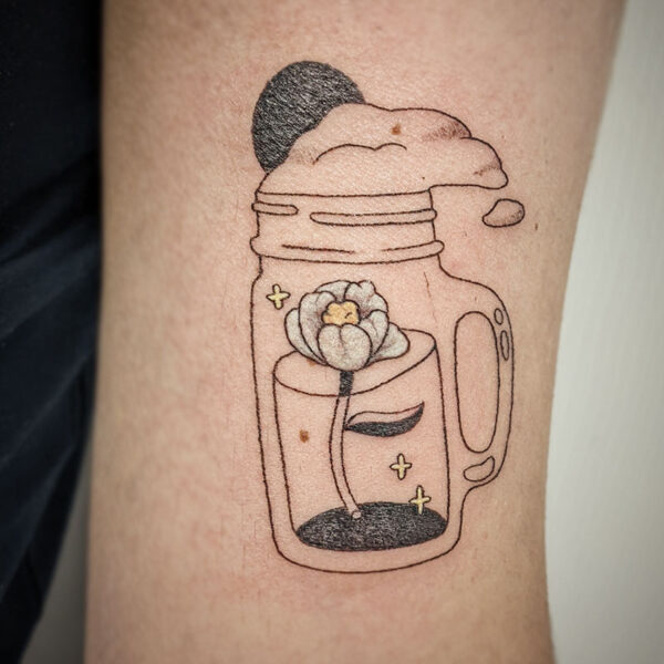 atticus tattoo, fine line tattoo of a beer bug with a white and yellow flower in it