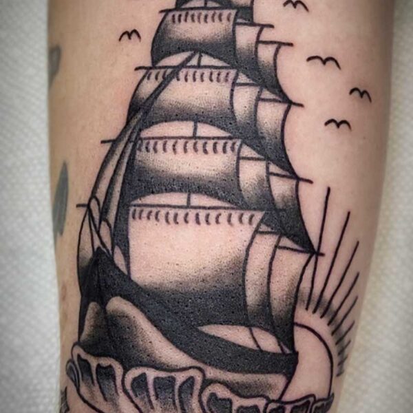 atticus tattoo, black and grey traditional tattoo of a sailing ship with waves, stars and birds