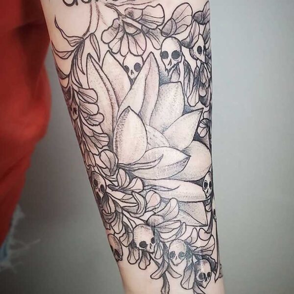 atticus tattoo, black and grey tattoo of a lotus surrounded by snapdragons