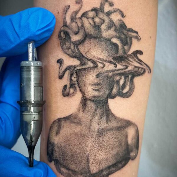atticus tattoo, black and grey tattoo of a bust of Medusa with her eyes "glitching"