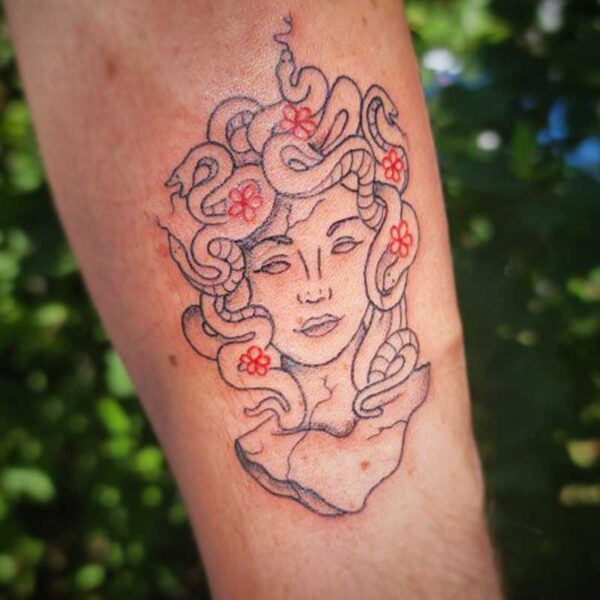 atticus tattoo, fine line tattoo of Medusa with red flowers in her hair