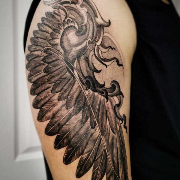 atticus tattoo, black and grey tattoo of large bird wing