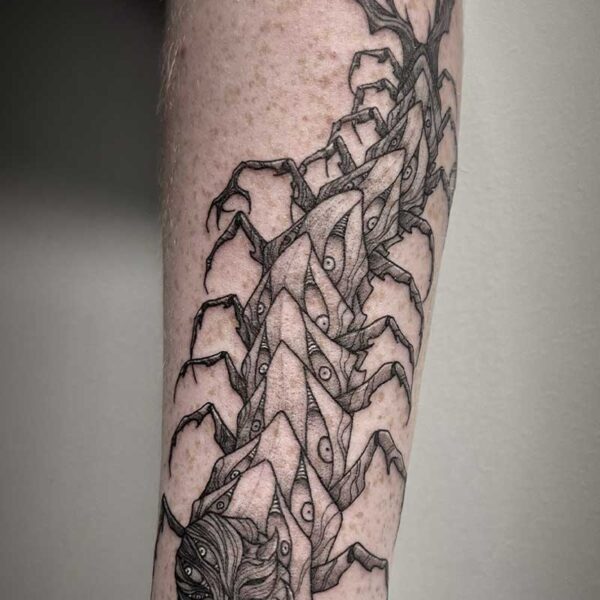 atticus tattoo, black and white tattoo of a centipede monster