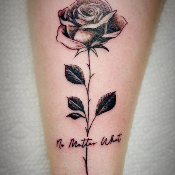 atticus tattoo, black and grey tattoo of a rose wkith the words "no matter what"