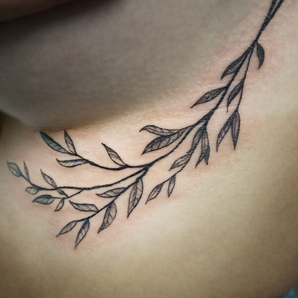 atticus tattoo, black and grey tattoo of a stem of leaves