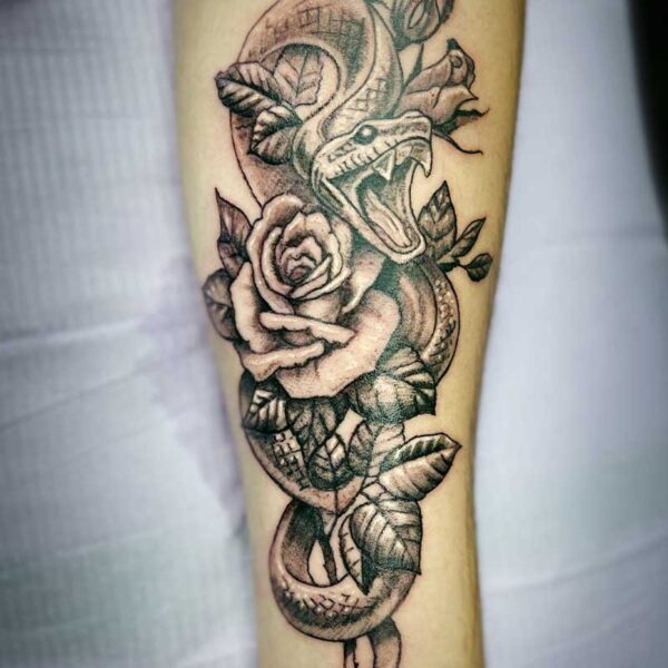 atticus tattoo, black and white tattoo of a snake wrapped around a rose and hissing