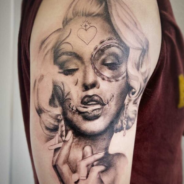 atticus tattoo, black and grey portrait tattoo of Marilyn Monroe smoking and with tattoos on her face