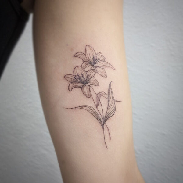 atticus tattoo, fine line tattoo of two lilies