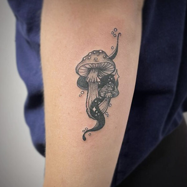 atticus tattoo, black and grey tattoo of mushrooms with sparkles and black smoke