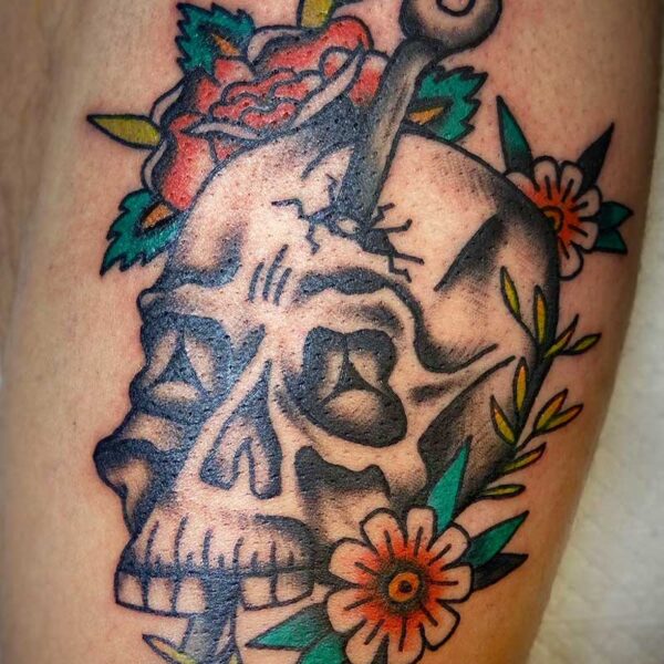 atticus tattoo, american traditional tattoo of a skull and dagger with flowers