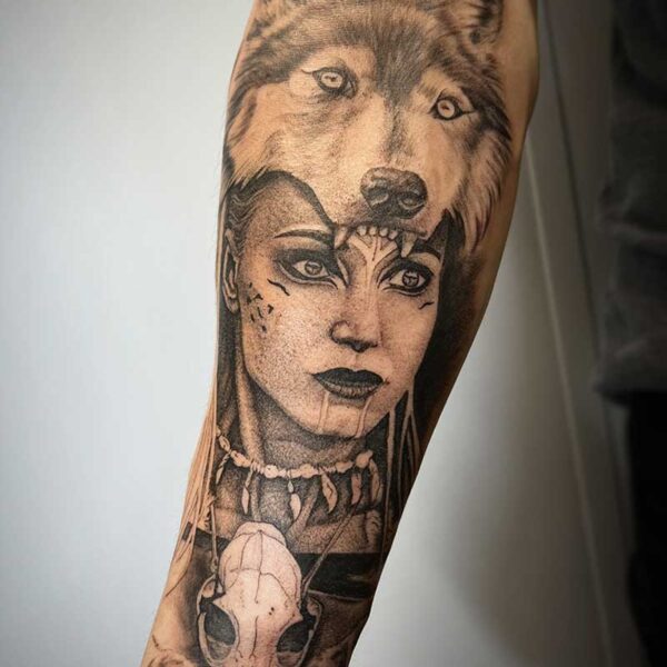 atticus tattoo, black and grey realism tattoo of an indigenous woman wearing a wolf skin