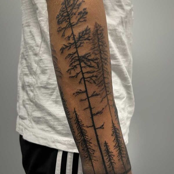 atticus tattoo, black sleeve tattoo of pine trees