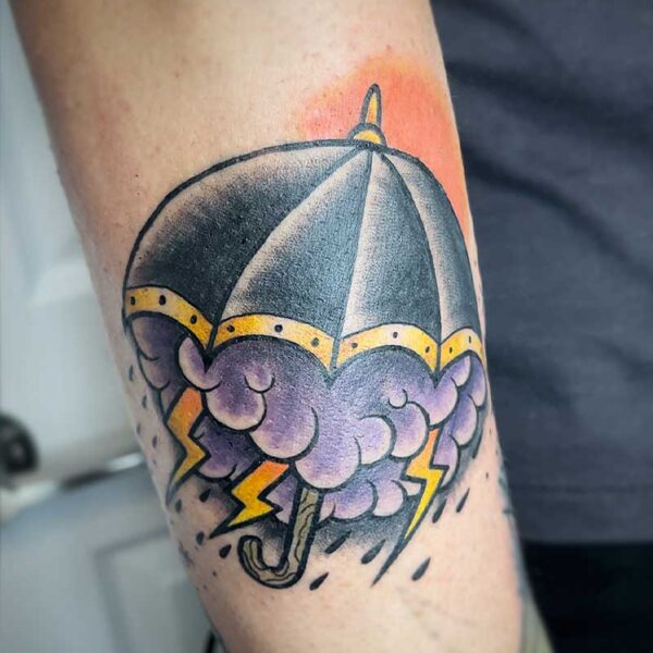 atticus tattoo, coloured neotraditional tattoo of an umbrella with a storm coming out of it