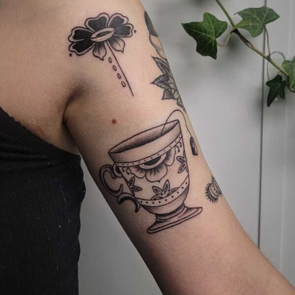 atticus tattoo, black and grey American traditional tattoo of a tea cup