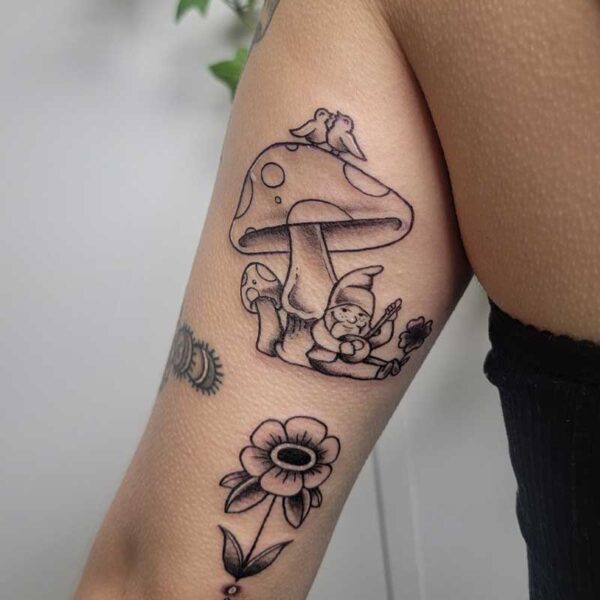 atticus tattoo, black and grey American traditional tattoo of a mushroom and a gnome