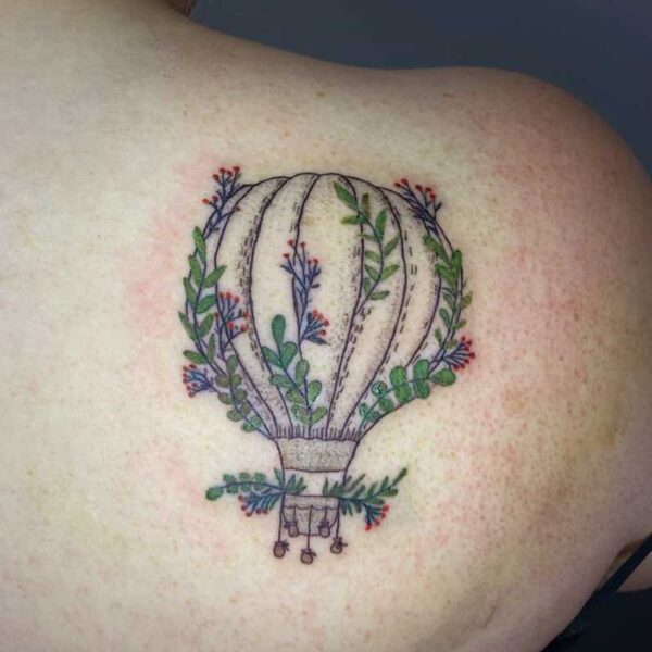 atticus tattoo, fine line tattoo of a hot air balloon with green vines and red flowers growing out of it