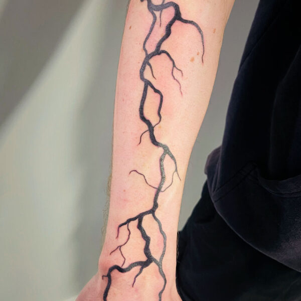 atticus tattoo, black tattoo of a lightning bolt