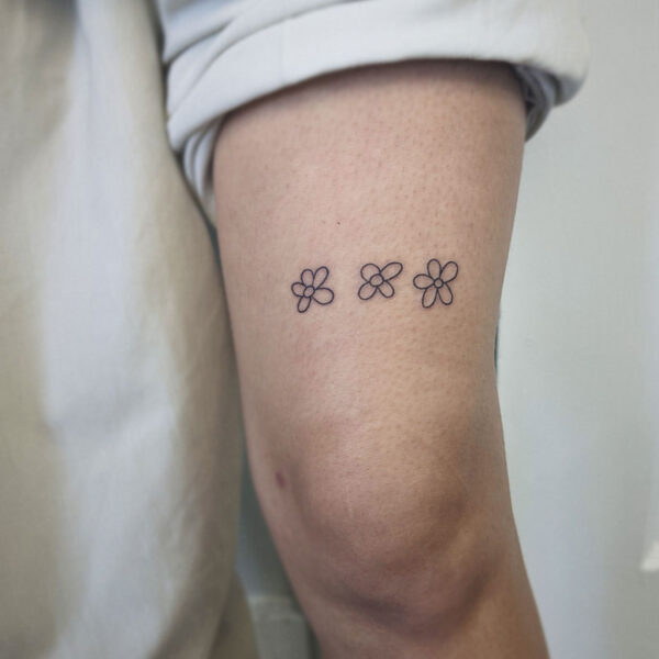 atticus tattoo, fine line tattoo of three flowers