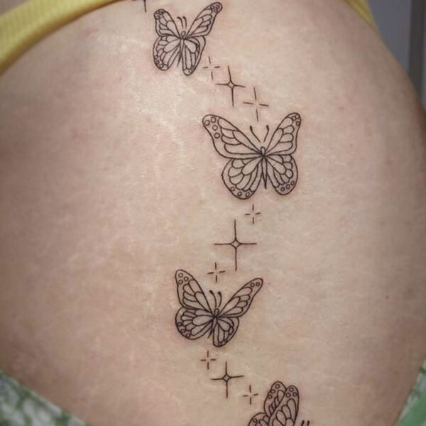 atticus tattoo, fine line tattoo of butterflies and sparkles