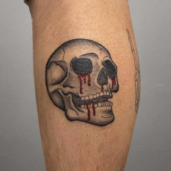 atticus tattoo, black and grey tattoo of a human skull with blood coming out of its eyes and mouth