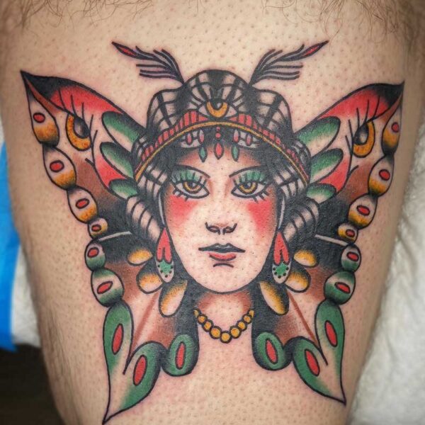 atticus tattoo, american traditional style tattoo of a woman's face with butterfly wings