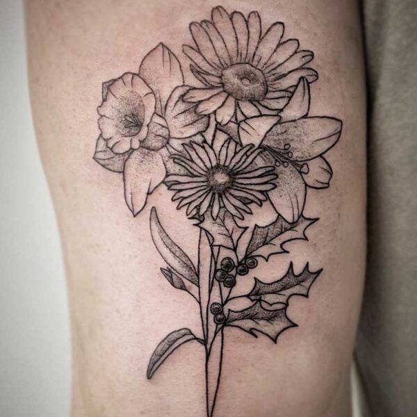 atticus tattoo, black and grey tattoo of daffodils, daisies and holly