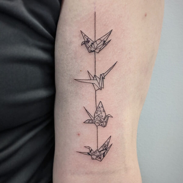 atticus tattoo, fine line tattoo of four origami birds on a string