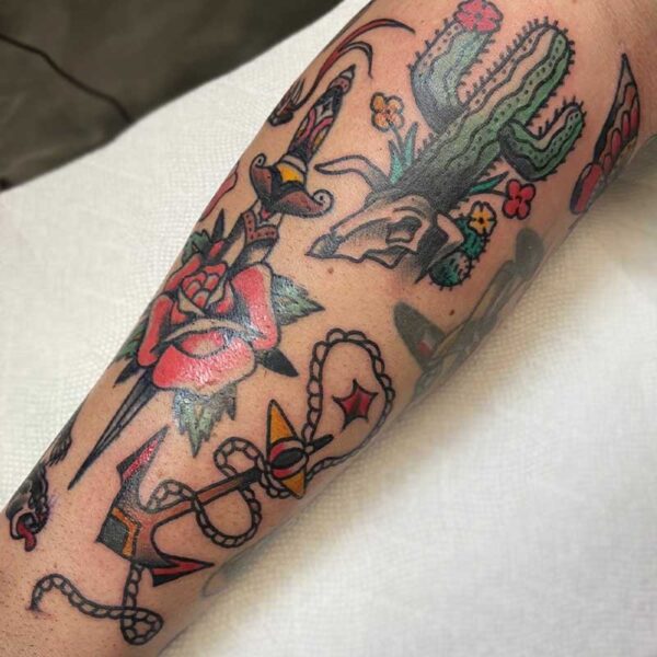 atticus tattoo, american traditional style tattoo sleeve with a rose and dagger, rope and anchor and a cactus and cow skull
