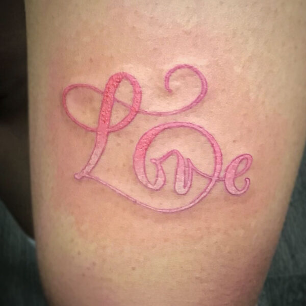 atticus tattoo, pink ombre tattoo of the word "Love"