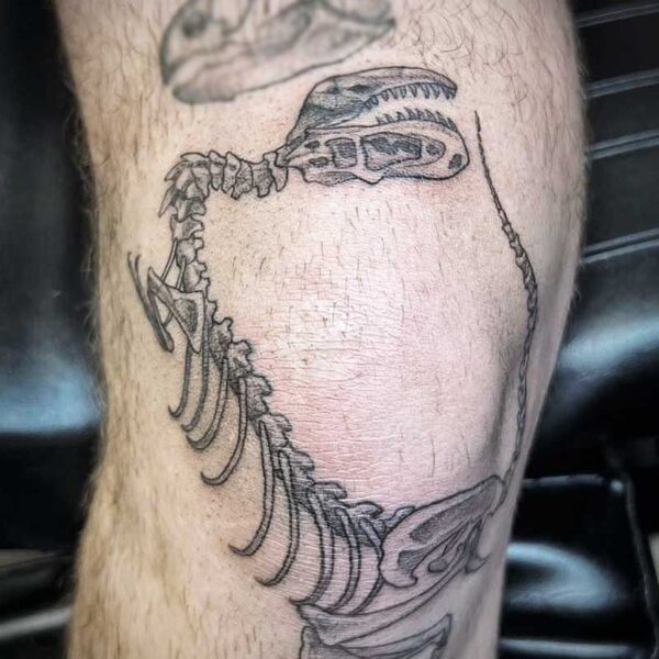 atticus tattoo, black and grey tattoo of a t-rex skeleton