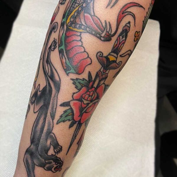 atticus tattoo, american traditional style tattoo sleeve with a rose and dagger, black panther and a snake head