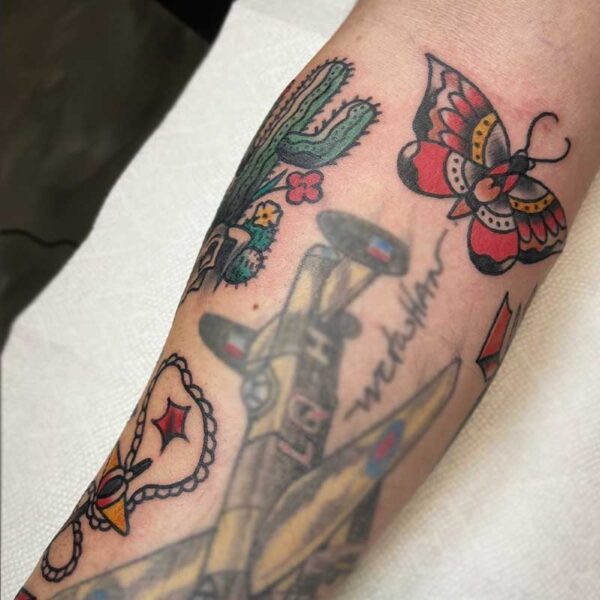 atticus tattoo, american traditional style tattoo sleeve with a cactus and cow skull, rope and anchor and a butterfly