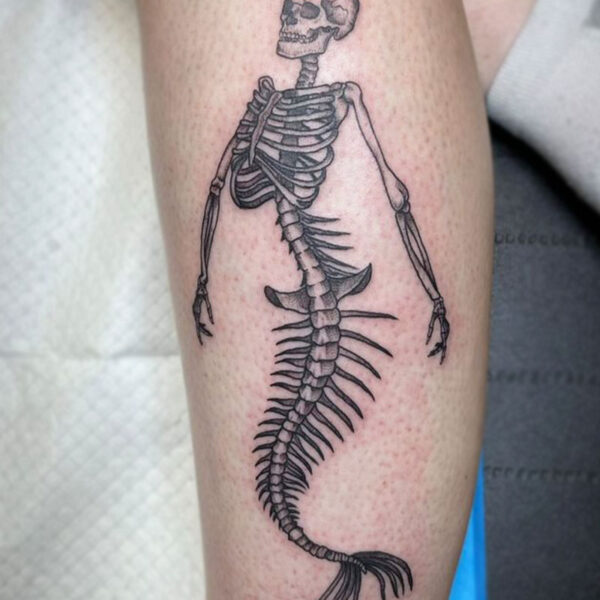 atticus tattoo, black and grey tattoo of a mermaid's skeleton