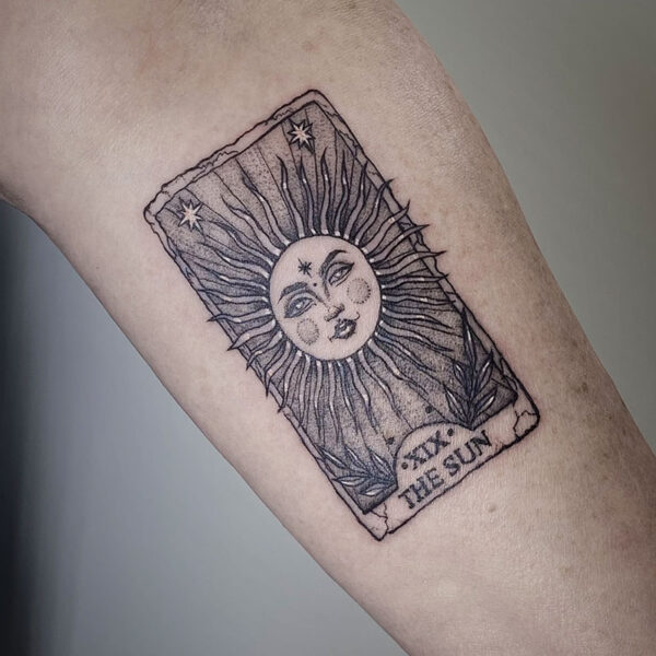 atticus tattoo, black and grey tattoo of a tarot card of the Sun