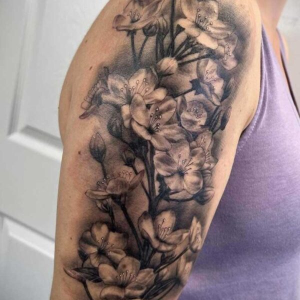 atticus tattoo, black and grey realism tattoo of a branch of Orchids